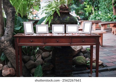 Blank Horizontal and Vertical Frames Mockup on Wooden Table in Lush Garden Setting