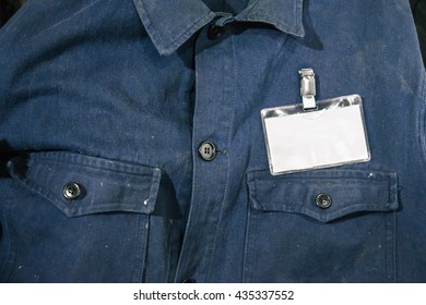 Blank id card on workman's jacket. Horizontal photography of a dirty blue jeans shirt with a white badge. - Shutterstock ID 435337552