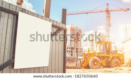 blank information banner with white mockup on metal construction site gate under bright sunlight outside