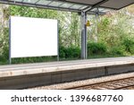 Blank information billboard or timetable located on train (s-bahn, u-bahn, metro) station. Railroad track on the bottom of the picture. Mock up design. 