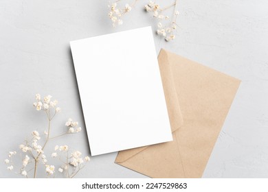 Blank invitation or greeting card mockup with flowers and envelope, wedding card flat lay - Shutterstock ID 2247529863