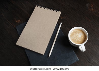 Blank kraft notebook, pencil and coffee cup. Branding mock up.