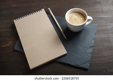 blank kraft sketchbook, pencil and coffee cup. Branding mock up.