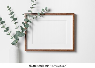 Blank Landscape Frame Mockup For Artwork Or Print On White Wall With Eucalyptus Plant In Vase