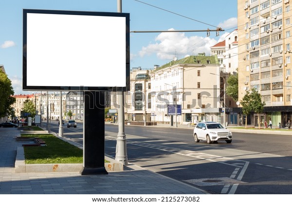 Blank large billboard in a residential area of\
the city. Mock-up.