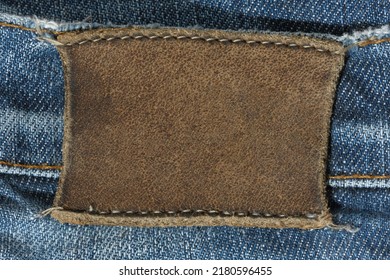 Blank Leather Tag On Jeans. A Place For Text, Mockup For Design.