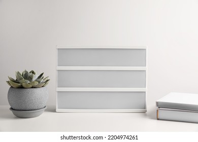 Blank Letter Board, Books And Beautiful Houseplant On White Table. Mockup For Design