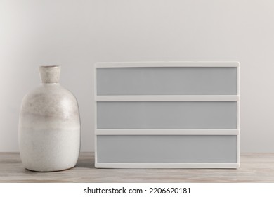 Blank Letter Board And Vase On Wooden Table. Mockup For Design