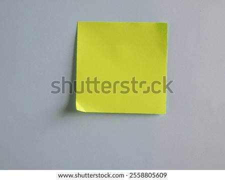 Blank light green post-it note on a grey background. Customize the dark tone.