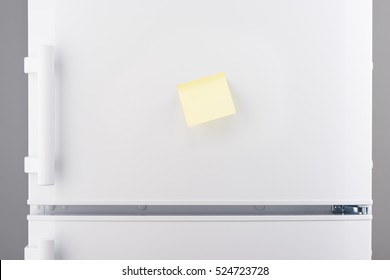 Blank Light Yellow Sticky Paper Note On White Refrigerator Door