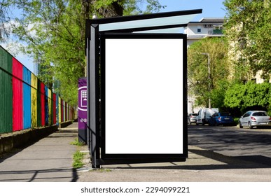 blank lightbox and glass bus shelter at busstop. urban street background. white ad poster. display panel. empty outdoor ad space. mockup base.  cars on the road. street setting. blurred surrounding.