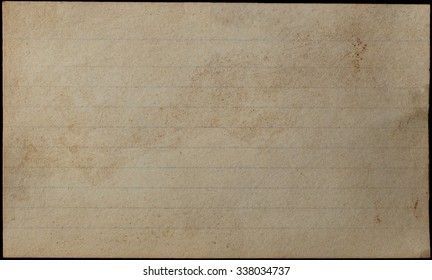 A Blank, Lined Index Card, Yellowed, Aged, Stained And Weathered For Grunge Or Vintage Effect.  Isolated On Black Background.