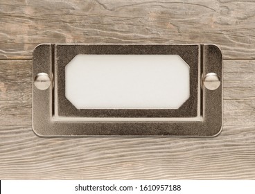 Blank Metal File Cabinet Label Frame On Wood Ready For Your Own Message.