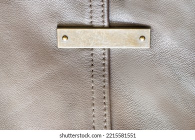 Blank Metal Nameplate On Grey Leather Background Closeup