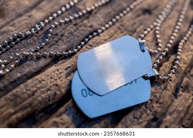 Blank military dog tags on abandoned metal plate. Memories and sacrifices concept. Still life disc necklace. Image for e-commerce, online selling, social media, jewelry sale. - Powered by Shutterstock