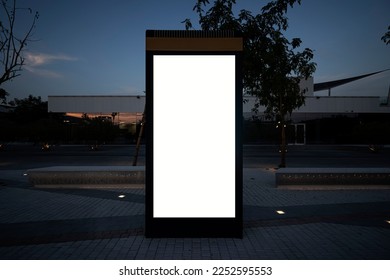 Blank mock up of vertical street poster billboard on city background. Electronic modern empty scoreboard on the background of a city street in the evening. copy space - Shutterstock ID 2252595553