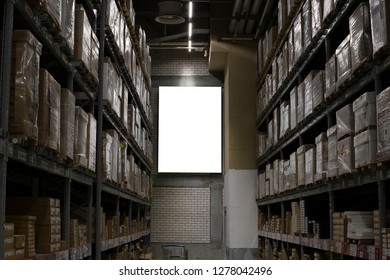 Blank Mockup Advertising With Copy Space On The Wall Of The Warehouse (storage) With Rows Of Shelves With Goods Boxes