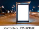 Blank Mockup Of Bus Stop Vertical Billboard On The Sidewalk At Night. Front View Of White Empty Outdoor Advertising Screen