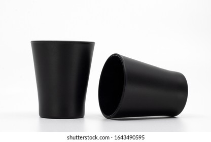 Blank Mockup Cups Isolated On White. Two Black Shot Glasses. Matte Glass Kitchenware. Empty Cups Or Containers.