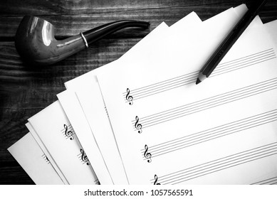 Blank Music Sheet, Pencil And A Smoking Pipe In Black And White