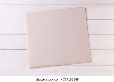 Blank Newspaper with empty Space for Text or Image on Wooden table. Top View of Daily Newspaper Mock up.