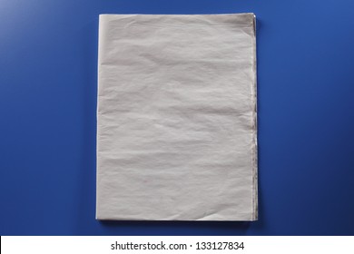 Blank newspaper on the blue background