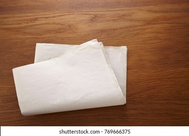 Blank Newspaper On The Wooden Table