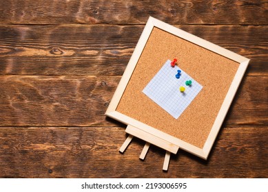 Blank Note Paper Pinned To The Small Pin Board On The Wooden Flat Lay Table Background. Task List Mockup. To Do List Template.