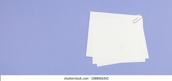 Blank note papers label with clip on purple background