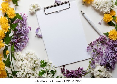 Blank note space with beautiful spring flowers and lilac.Top view