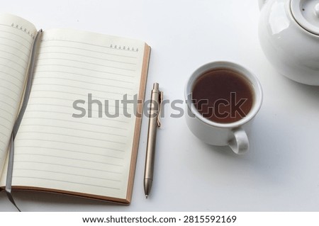 Blank Notebook Next to Cup of Tea for Writing Journaling and Planning