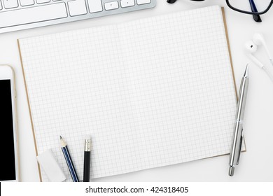 Blank notebook is open on modern white working table. Top view. - Shutterstock ID 424318405