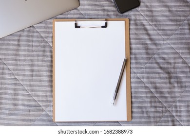 Blank Notebook With Pencil, Cell Phone On Bed. Unemployment. Cash Crunch. Lack Of Money. Job Seeker. 