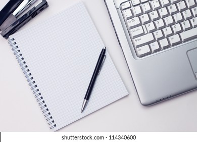 blank notepad and laptop in the office