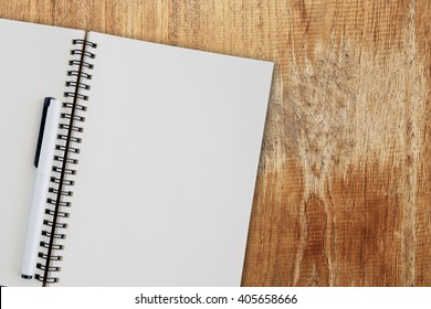 Blank Notepad On Wooden Table.