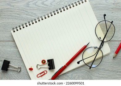 Blank notepad page for entering text in the middle. glasses and a red pen. Top view, flat lay. - Shutterstock ID 2260099501