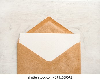 Blank notepad sheet for your congratulatory message. Close-up, view from above, wooden surface. No people. Concept of preparation for a holiday. Congratulations for relatives, friends and colleagues