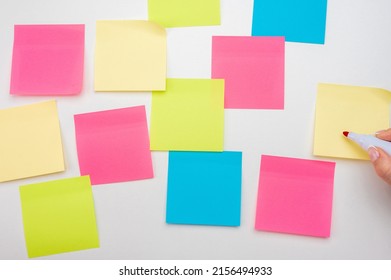 Blank Notes On White Background. Mockup Sticky Note Paper. Empty Sheets For Notes On White Bulletin Board. Hand With Red Marker Ready To Write