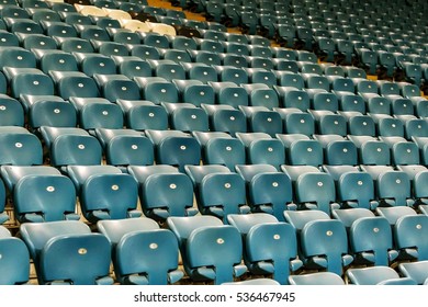 Blank old plastic chairs at the stadium. Number of empty seats in a small old stadium. Scratched worn plastic seats for fans - Shutterstock ID 536467945
