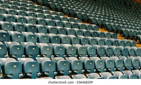 Blank old plastic chairs at the stadium. Number of empty seats in a small old stadium. Scratched worn plastic seats for fans - Shutterstock ID 536468209