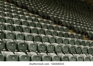 Blank old plastic chairs at the stadium. Number of empty seats in a small old stadium. Scratched worn plastic seats for fans - Shutterstock ID 536500315