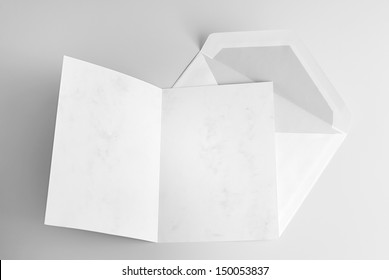 Blank Open Card And Envelope Over Grey Background With Shadow