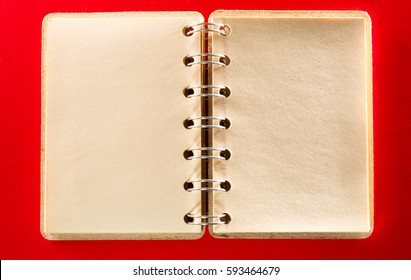 Blank open notebook on the red background