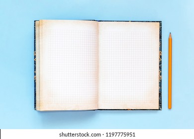 Blank open Notepad and pencil. empty notebook on blue background. Copy space