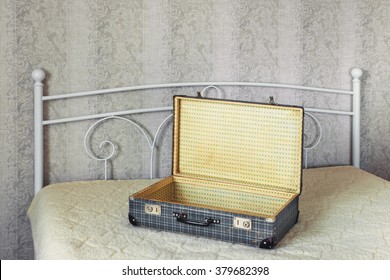 Blank Open Suitcase Standing On A Wide Bed