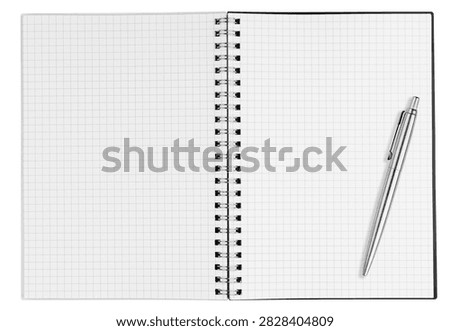 Blank open vertical graph notebook with checkered pages and silver ballpoint pen isolated on white background. Top view portrait notepad mockup template for business, accounting and coding