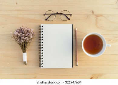 Blank Opened Notebook With Teacup And Flowers On Table. Writing Concept.