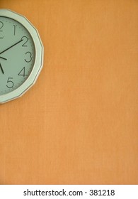 blank orange wall with a half a clock