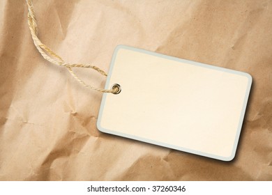 Blank packaging label with cotton string on crumpled brown paper - Shutterstock ID 37260346
