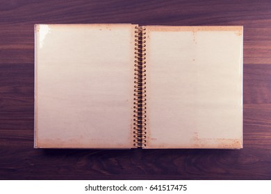 Blank Page Of An 1970s Photo Album, In Muted Retro Tone, On A Dark Colored Wooden Table. 